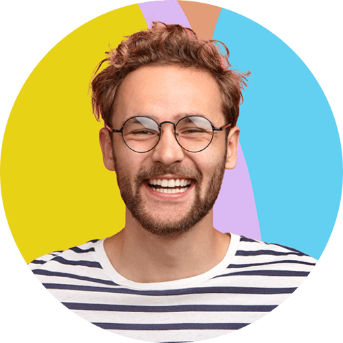 Portrait of a smiling person with curly hair, glasses, and a striped shirt against a colourful background.